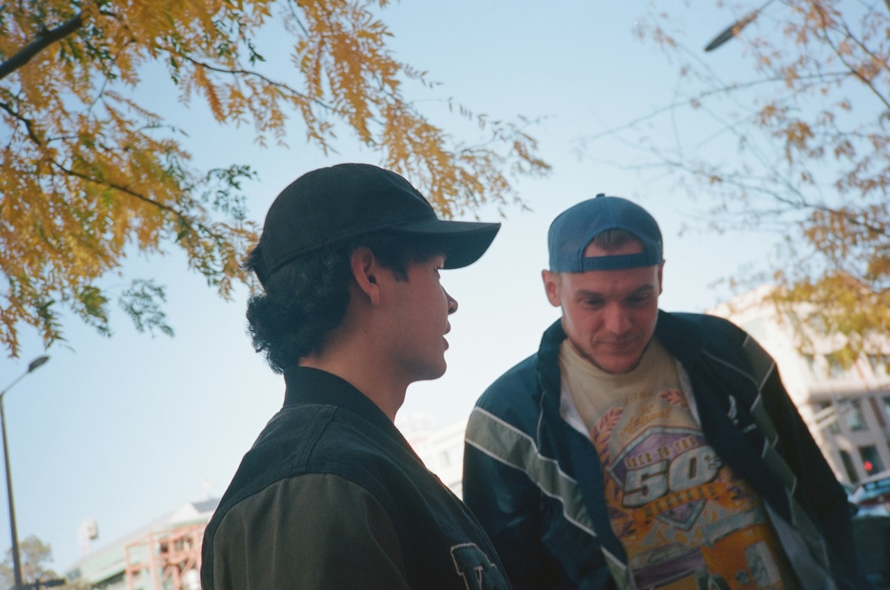 Two men standing outside having a conversation