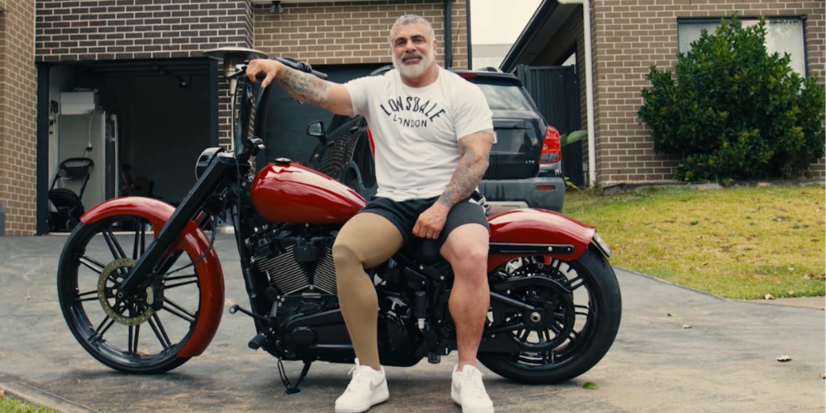 Fabian sitting on hist motorbike in the driveway
